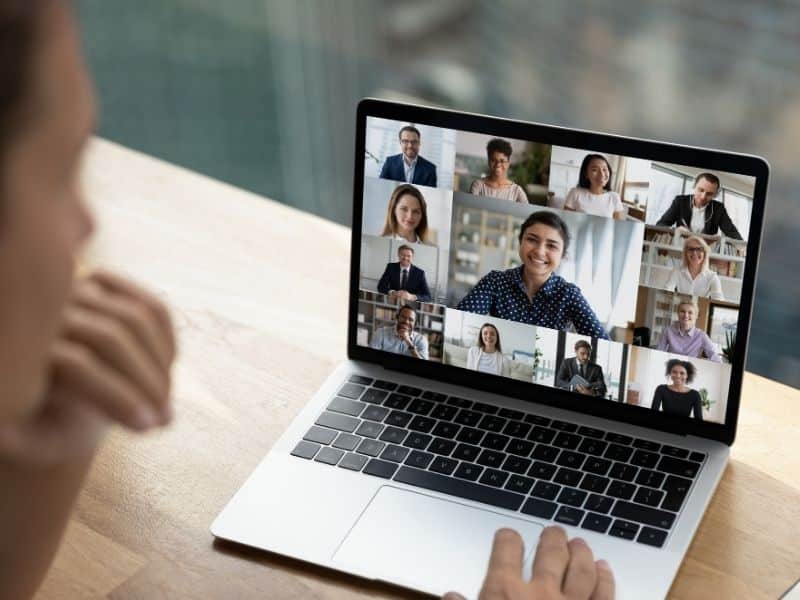 Professional participating in a virtual team meeting on a laptop