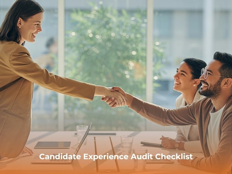 A candidate shakes the hands or two members of a hiring team, highlighting the candidate experience in hiring.